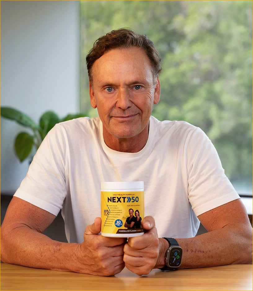 Man holding NEXT50 Daily Health Formula